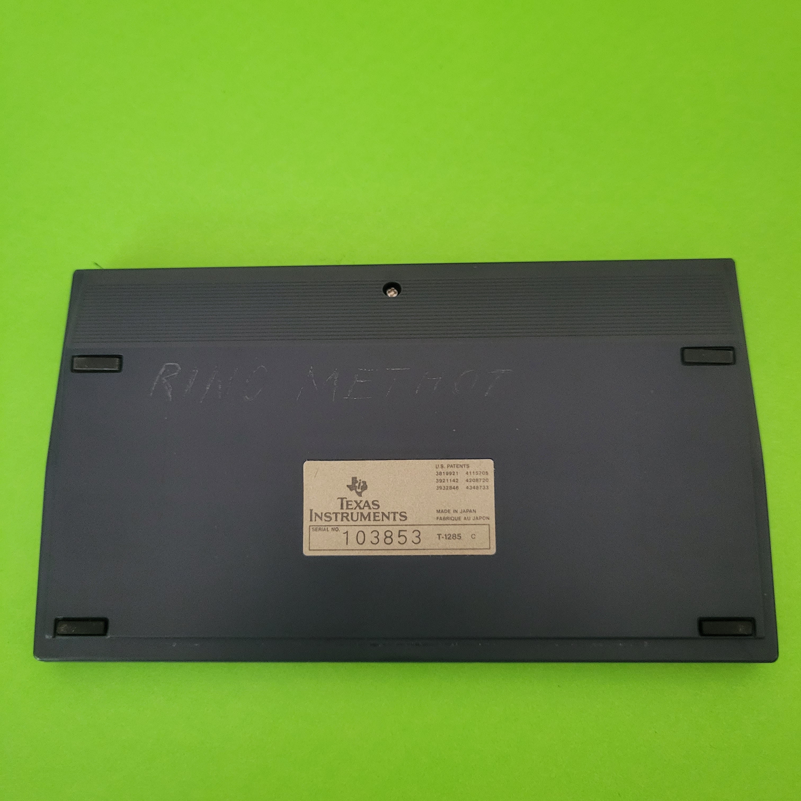 An image of the back of a texas instruments ti37 galaxy solar scientific/engineering calculator